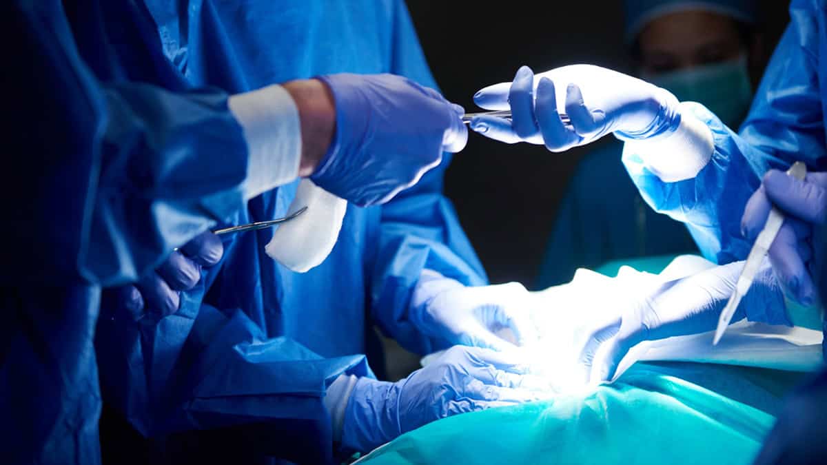 Surgeons performing surgery on a leg
