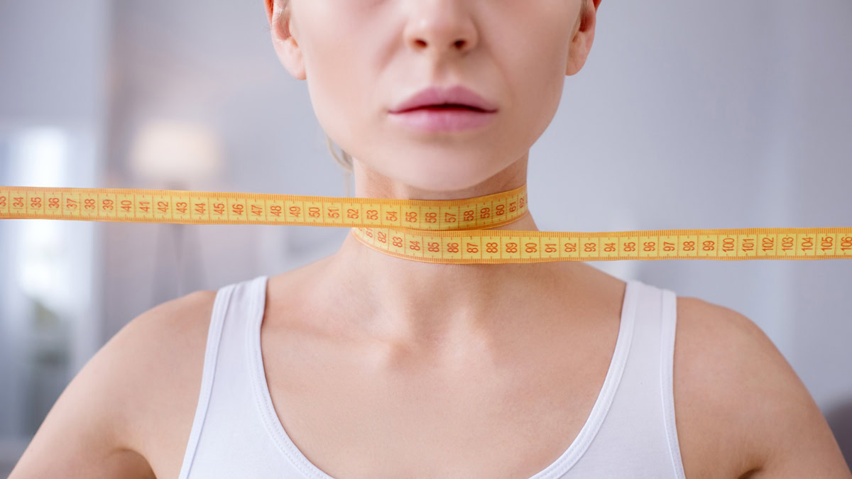 Person with measuring tape around her neck