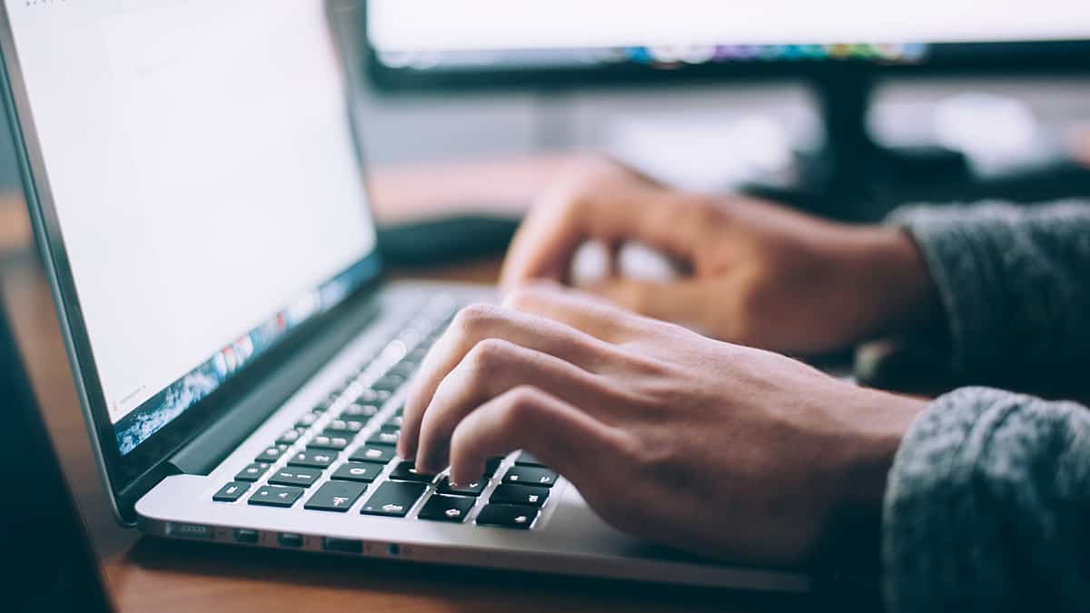 Guy using a silver laptop