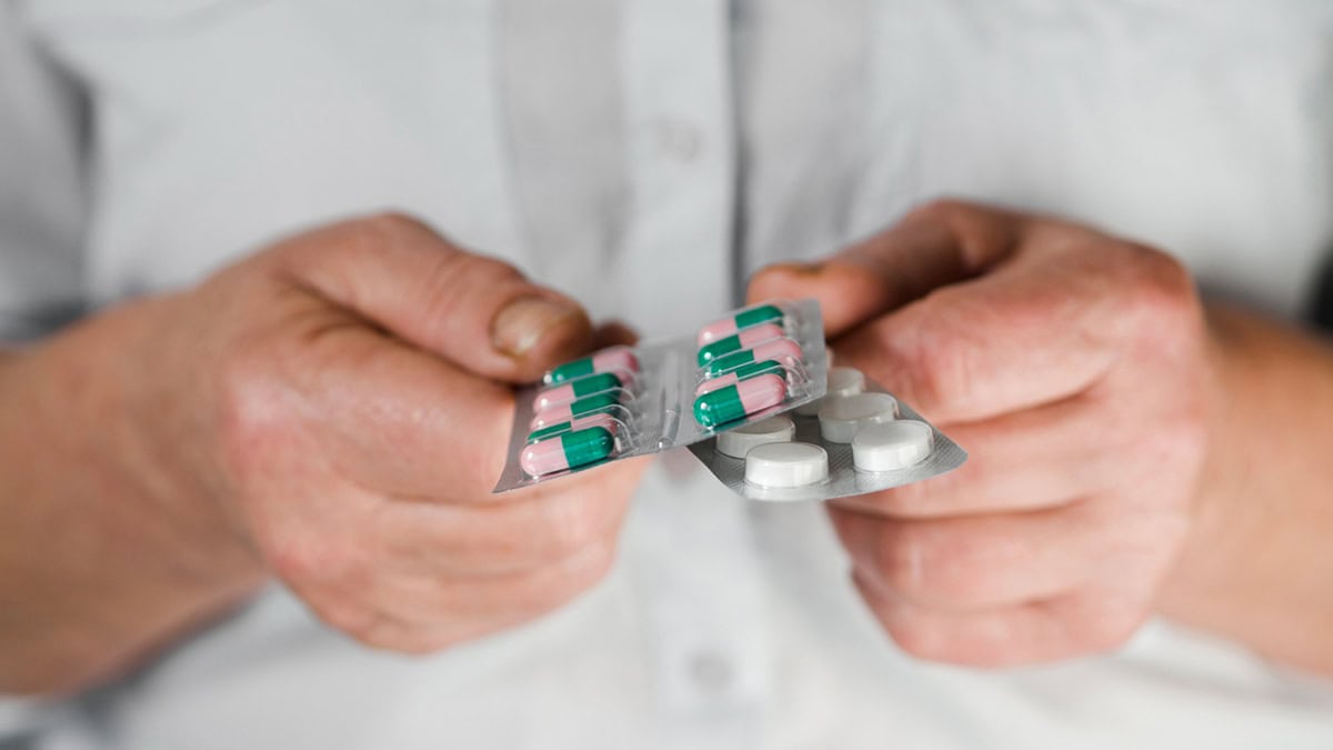 Person comparing two tablet packs