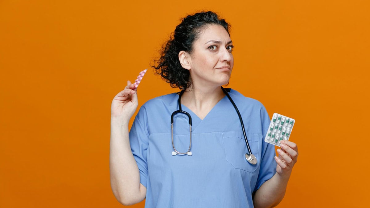 Vet holding two types of tablet packs