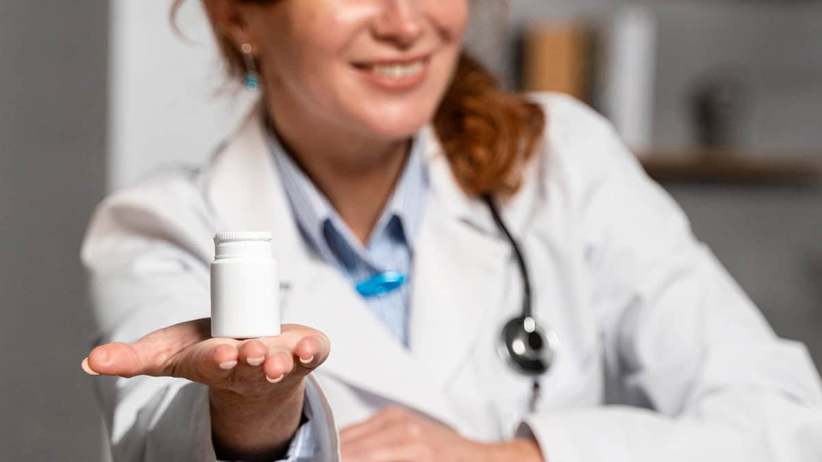 Doctor holding medication bottle