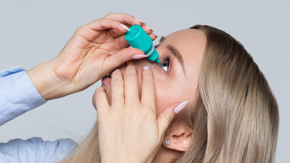 Person using eye drops