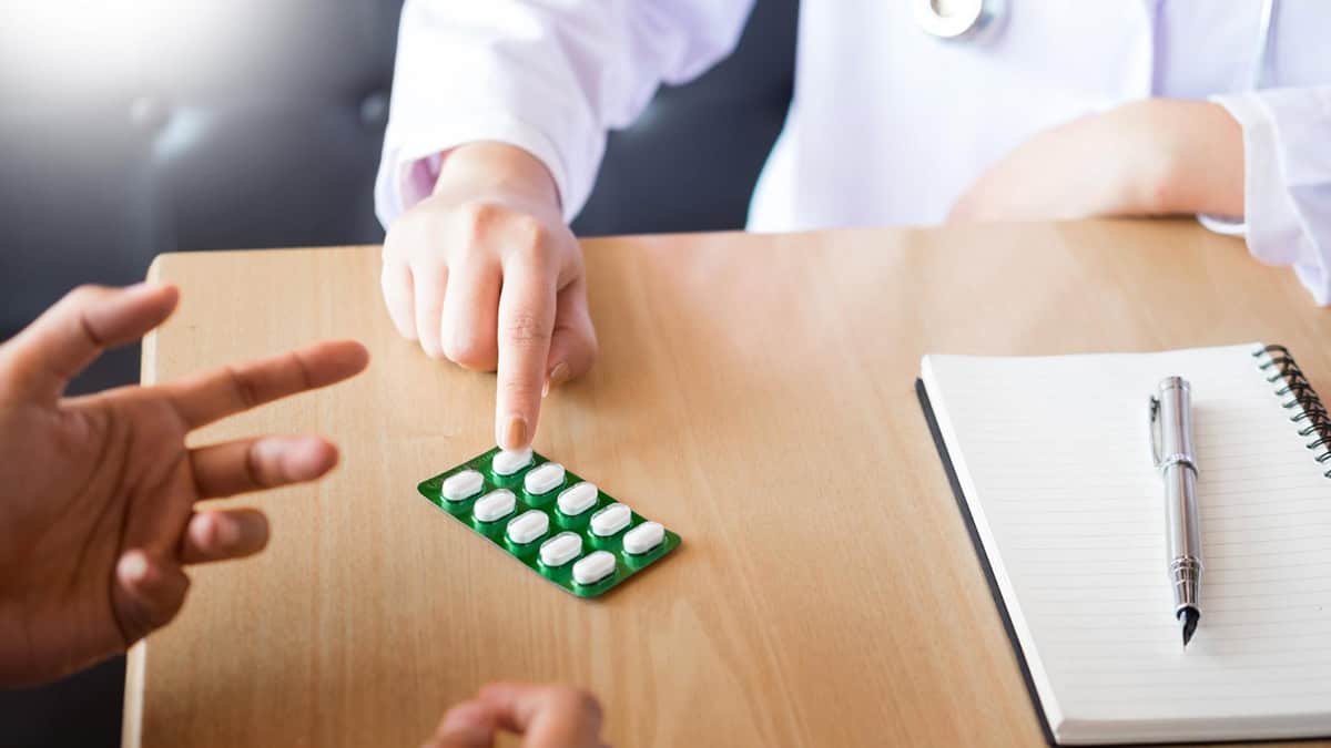 Doctor giving tablet pack to patient