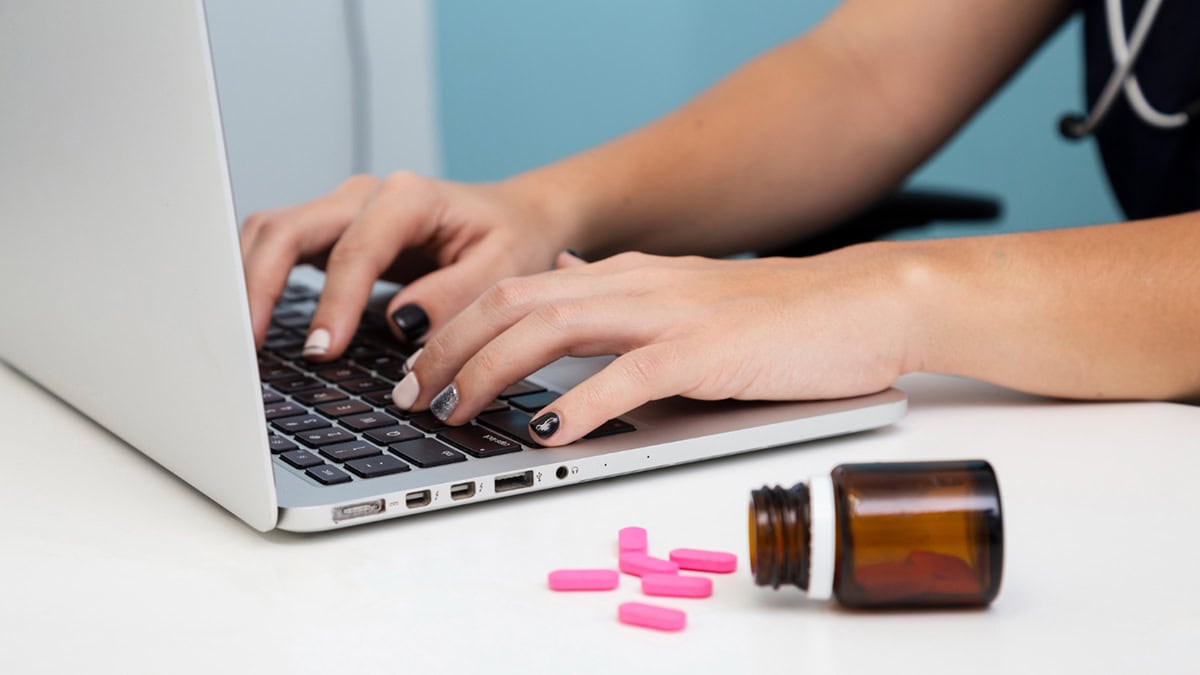 Person on laptop shopping medications online